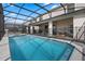 Screened pool with lounge chairs offer an outdoor living space for relaxation and enjoyment at 4353 Lana Ave, Davenport, FL 33897