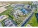 Aerial photo displays a large pool and water park, tennis court, and miniature golf amid residential housing at 4353 Lana Ave, Davenport, FL 33897