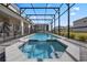 Relaxing screened-in pool and spa area with a backyard view and brick-paved pool deck at 4353 Lana Ave, Davenport, FL 33897