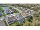 An aerial view of a neighborhood featuring many houses and a scenic pond with a fountain at 4419 Liberty Bell Cv, Orlando, FL 32817