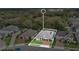 An aerial view showcases a house with pool, a well manicured lot, and neighborhood surroundings at 4419 Liberty Bell Cv, Orlando, FL 32817