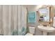 Cozy bathroom featuring a pedestal sink, framed mirror and patterned shower curtain at 4419 Liberty Bell Cv, Orlando, FL 32817