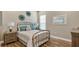 Comfortable bedroom with elegant decor, plush bedding, and wood-look tile flooring at 4419 Liberty Bell Cv, Orlando, FL 32817