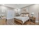 Comfortable bedroom featuring wood-look floors, a wooden bed frame, a large art piece, and sliding glass doors at 4419 Liberty Bell Cv, Orlando, FL 32817