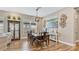 Warm dining space with dark wood table and hutch, and decorative wall art at 4419 Liberty Bell Cv, Orlando, FL 32817