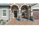 Close-up of a home's welcoming stone entrance, accentuated by arched details and potted plants at 4419 Liberty Bell Cv, Orlando, FL 32817