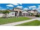 Beautiful home featuring stone accents, a three-car garage, and well-maintained landscaping at 4419 Liberty Bell Cv, Orlando, FL 32817