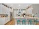 Bright, modern kitchen with white cabinetry, stainless appliances, and breakfast bar seating at 4419 Liberty Bell Cv, Orlando, FL 32817
