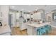 Contemporary kitchen featuring white cabinets, granite countertops, and bar seating at 4419 Liberty Bell Cv, Orlando, FL 32817