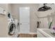 Practical laundry room featuring modern washer, dryer, and ample storage space at 4419 Liberty Bell Cv, Orlando, FL 32817
