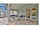 Inviting patio features comfortable seating, tile floors, stucco columns, and sliding glass doors leading to the home's interior at 4419 Liberty Bell Cv, Orlando, FL 32817