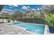 Enclosed pool area with a spa, patio, and mature landscaping at 4419 Liberty Bell Cv, Orlando, FL 32817