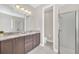 Bathroom with dual sink vanity and glass-enclosed shower at 480 Burma St, Kissimmee, FL 34747