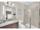 Clean and modern bathroom featuring granite countertops, a glass enclosed shower, and neutral paint at 480 Burma St, Kissimmee, FL 34747