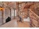 Themed bedroom featuring stone walls, bed alcove, and stone staircase offers a playful and unique sleeping space at 480 Burma St, Kissimmee, FL 34747