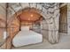 Themed bedroom featuring stone walls, bed alcove, and stone staircase offers a playful and unique sleeping space at 480 Burma St, Kissimmee, FL 34747