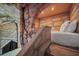 Themed bedroom featuring stone walls, bed alcove, and stone staircase offers a playful and unique sleeping space at 480 Burma St, Kissimmee, FL 34747