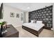 Bedroom featuring a large bed with dark furniture and a black and white design wall at 480 Burma St, Kissimmee, FL 34747