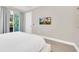 Spacious bedroom featuring a mounted TV and access to a patio at 480 Burma St, Kissimmee, FL 34747