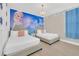 Themed bedroom featuring two beds, chandelier and Frozen mural offers a playful and magical sleeping space at 480 Burma St, Kissimmee, FL 34747