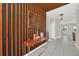 Inviting entrance with a decorative wood accent wall and modern console table leading into the home at 480 Burma St, Kissimmee, FL 34747