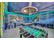 Spacious game room with a pool table, foosball table, and space theme decor, perfect for entertainment at 480 Burma St, Kissimmee, FL 34747
