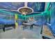 Spacious game room with unique space theme decor, offering a pool table, foosball, and shuffleboard table at 480 Burma St, Kissimmee, FL 34747