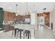 Large kitchen island with seating and stainless steel appliances, open to the entryway and adjacent rooms at 480 Burma St, Kissimmee, FL 34747