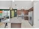 Spacious kitchen features stainless steel appliances, granite countertops, and modern lighting fixtures at 480 Burma St, Kissimmee, FL 34747