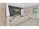 Modern living room with stylish accent wall, comfortable seating, and ample natural light from the windows at 480 Burma St, Kissimmee, FL 34747