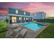 Backyard pool and spa with lounge chairs, perfect for relaxing and entertaining, under a stunning sunset at 480 Burma St, Kissimmee, FL 34747