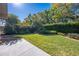 Expansive backyard with a concrete patio, lawn, and beautiful landscaping, creating a serene outdoor space at 4933 Raylene Way, St Cloud, FL 34771