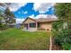Landscaped backyard showing patio, lush lawn, and well-maintained garden beds around the perimeter at 4933 Raylene Way, St Cloud, FL 34771