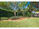 Backyard boasts lush lawn, mature trees, and beautifully landscaped borders, enhancing privacy at 4933 Raylene Way, St Cloud, FL 34771