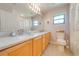 Bright bathroom with double sinks, neutral walls, and a large mirror at 4933 Raylene Way, St Cloud, FL 34771