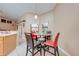 Cozy dining area features a glass table, bright windows, and a neutral color palette at 4933 Raylene Way, St Cloud, FL 34771