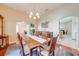 Formal dining room featuring hardwood floors, elegant decor, and plenty of natural light with access to office at 4933 Raylene Way, St Cloud, FL 34771