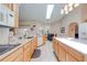 Well-lit kitchen with an island, bright cabinets, and tiled floors at 4933 Raylene Way, St Cloud, FL 34771