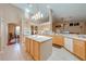 Charming kitchen with island, bright cabinets, and tile floors at 4933 Raylene Way, St Cloud, FL 34771