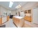 Well-lit kitchen with an island, bright cabinets, and tiled floors at 4933 Raylene Way, St Cloud, FL 34771