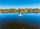 Picturesque shot of dock in the middle of the lake with trees surrounding the edge at 4933 Raylene Way, St Cloud, FL 34771