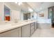 Luxurious bathroom featuring dual sinks, modern fixtures, and a separate tub and shower at 4933 Raylene Way, St Cloud, FL 34771
