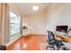 Spacious office with hardwood floors, large window, and stylish decor with access to the dining room at 4933 Raylene Way, St Cloud, FL 34771