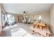 Enclosed patio offering various seating options, a ceiling fan, and a wooden picnic table for outdoor dining at 4933 Raylene Way, St Cloud, FL 34771
