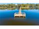 Picturesque lake pier with a wooden platform and ladder offers stunning views at 4933 Raylene Way, St Cloud, FL 34771