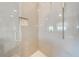 Close up of the shower showcasing sleek tile work, rainfall shower head and glass door at 4933 Raylene Way, St Cloud, FL 34771