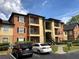 View of the building's exterior, showcasing the architecture and surrounding landscape with parking at 5959 Westgate Dr # 1526, Orlando, FL 32835