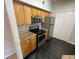 A kitchen with stainless steel appliances and black tile floor at 5959 Westgate Dr # 1526, Orlando, FL 32835