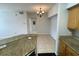 This open-concept kitchen has light-toned wood cabinets and beautiful granite countertops at 5959 Westgate Dr # 1526, Orlando, FL 32835