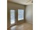 The space is bright with natural light from the door and window; tan tile floors at 5959 Westgate Dr # 1526, Orlando, FL 32835